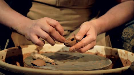 A-potter-manually-shapes-a-clay-spoon.