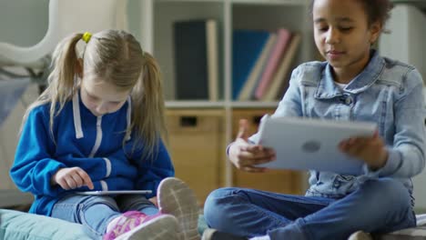 Little-Girls-Playing-on-Digital-Tablets