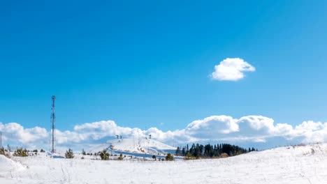 Long-time-lapse-of-clouds-over-winter-landscape