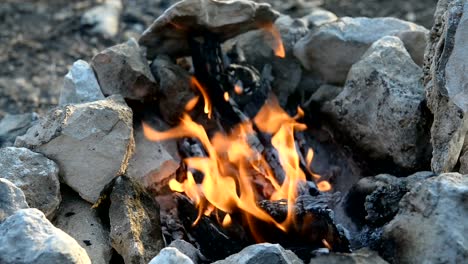 Bonfire-in-a-camp-fire-of-stones-outdoors