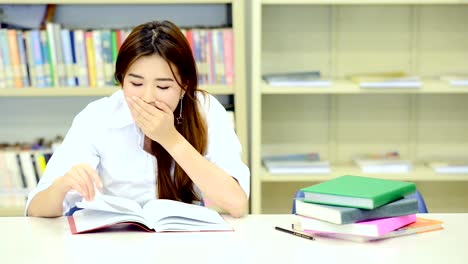 Study-hard-in-library.-Young-Chinese-girl-study-hard-at-library.-Fall-to-sleep.