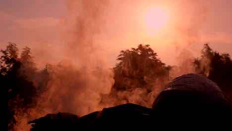 Slow-motion-fire-burning-garbage-bag-on-sunrise-dark-backgorund.