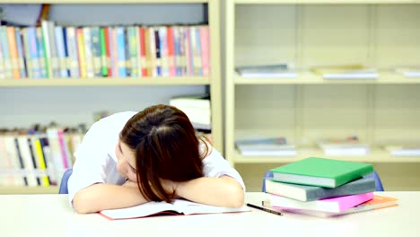 Study-hard-in-library.-Young-Chinese-girl-study-hard-at-library.-Fall-to-sleep.