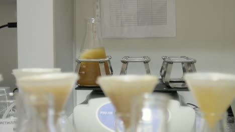 Chemical-Flasks-With-Colorful-Liquids-Shaking-at-the-Laboratory