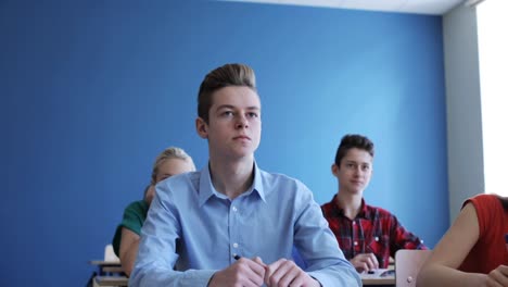 students-with-notebooks-on-lesson-at-school