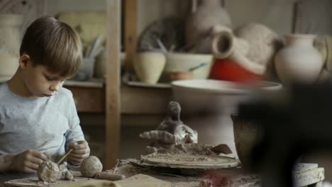 Boy-Sculpting-with-Clay-in-Pottery-Workshop