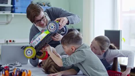 Teacher-Showing-Car-Model-to-Students