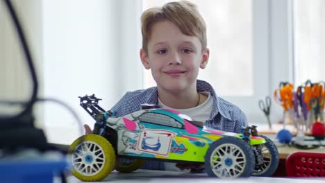 Portrait-of-Boy-Holding-Toy-Car