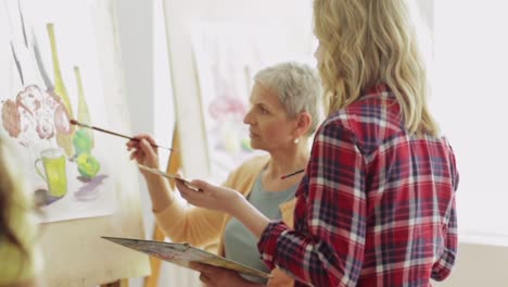 students-with-easels-painting-at-art-school