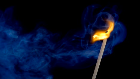 Burning-match-on-a-black-background-in-slow-motion