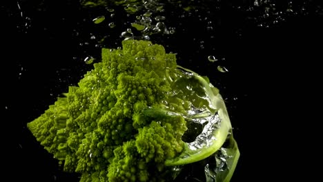 Falling-of-cabbage-of-broccoli-in-water.-Slow-motion.