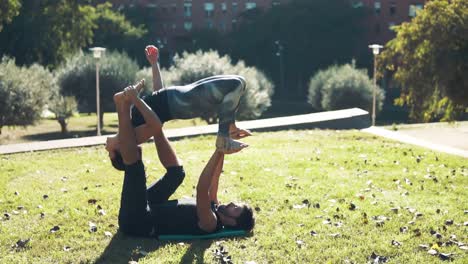 Beautiful-couple-practicing-acro-yoga-in-the-morning