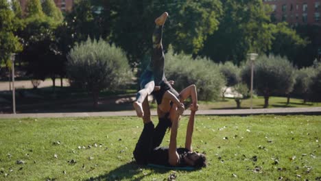 Beautiful-couple-practicing-acro-yoga-in-the-morning