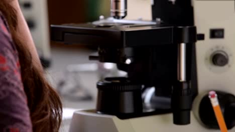 A-college-student-takes-a-class-and-uses-some-microscopes