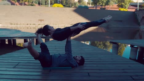 Beautiful-couple-practicing-acro-yoga-in-the-morning