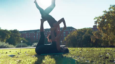 Beautiful-couple-practicing-acro-yoga-in-the-morning