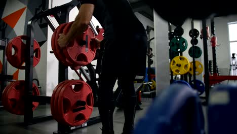 Gym.-A-man-comes-to-the-simulator.-Starts-to-lift-the-weight-with-their-feet-4K-Slow-Mo