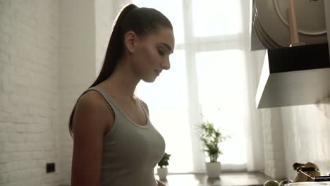 Beautiful-Young-Woman-At-Light-Sunny-Kitchen-In-Morning