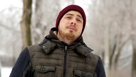 Young-man-waiting-for-someone-in-the-winter-city