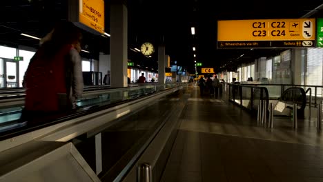 People-with-suitcases-walking-to-departure-hall-at-airport-terminal,-traveling