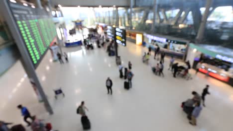 Top-view-of-abstract-blur-airport-terminal-with-commuter-crowd-of-people-and-passenger-walking-when-track-arriving-or-departing-flights,-Blurred-busy-Airport-Terminal-footage-concept.-Full-HD1920x1080