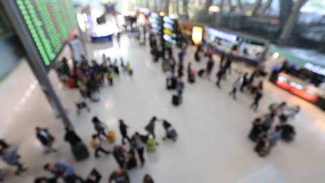 Top-view-of-abstract-blur-airport-terminal-with-commuter-crowd-of-people-and-passenger-walking-when-track-arriving-or-departing-flights,-Blurred-busy-Airport-Terminal-footage-concept.-Full-HD1920x1080