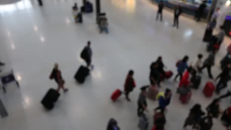 Top-view-of-abstract-blur-airport-terminal-with-commuter-crowd-of-people-and-passenger-walking-when-track-arriving-or-departing-flights,-Blurred-busy-Airport-Terminal-footage-concept.-Full-HD1920x1080