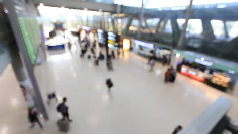 Top-view-of-abstract-blur-airport-terminal-with-commuter-crowd-of-people-and-passenger-walking-when-track-arriving-or-departing-flights,-Blurred-busy-Airport-Terminal-footage-concept.-Full-HD1920x1080