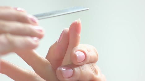 Beautician-filing-nails,-slow-motion.