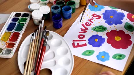 Child's-hand-draw-colorful-flowers