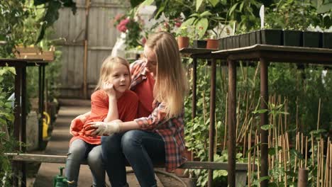 Woman-and-Girl-Resting-in-Greenhouse