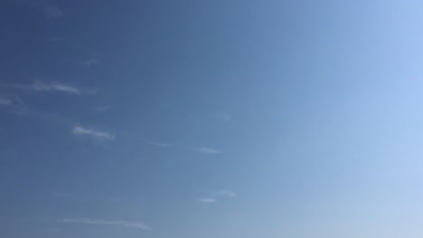 White-clouds-disappear-in-the-hot-sun-on-blue-sky.-Time-lapse-motion-clouds-blue-sky-background.-Blue-sky.-Clouds.-Blue-sky-with-white-clouds-and-sun.