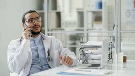 Doctor-Having-Phone-Conversation-at-Work