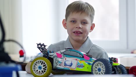 Retrato-de-niño-lindo-con-coche-de-juguete