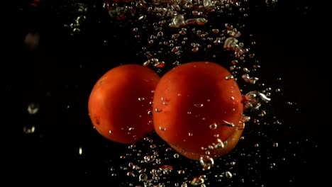 Falling-of-tomato-in-water.-Slow-motion.