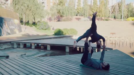 Beautiful-couple-practicing-acro-yoga-in-the-morning