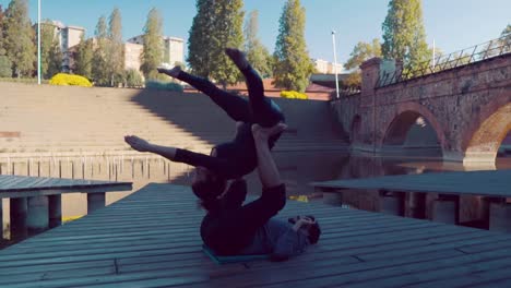 Beautiful-couple-practicing-acro-yoga-in-the-morning