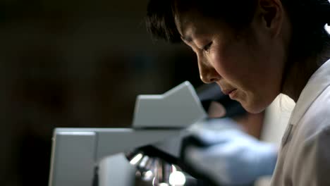 Students-in-a-chemistry-lab-look-through-a-microscope-during-their-experiments