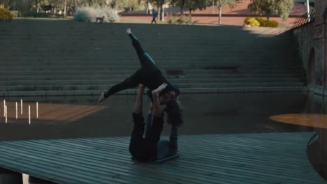 Beautiful-couple-practicing-acro-yoga-in-the-morning