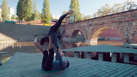 Beautiful-couple-practicing-acro-yoga-in-the-morning