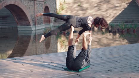 Beautiful-couple-practicing-acro-yoga-in-the-morning