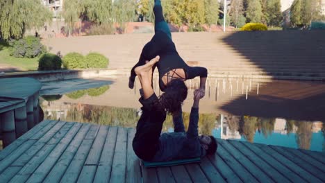 Beautiful-couple-practicing-acro-yoga-in-the-morning