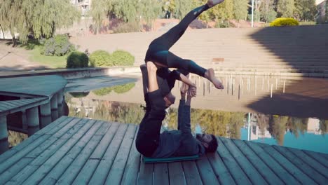 Beautiful-couple-practicing-acro-yoga-in-the-morning