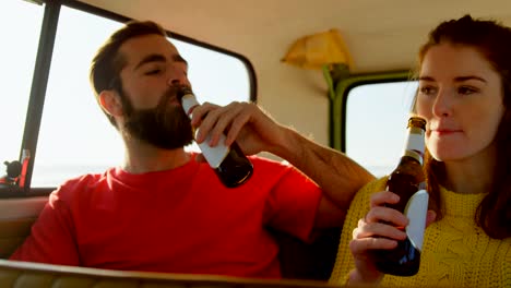 Young-couple-drinking-beer-in-van-4k