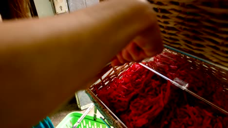 Close-up-of-woman-packing-snacks-in-supermarket-4k