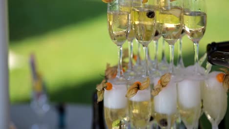 the-groom-and-the-bride-poured-champagne-into-the-wine-glasses