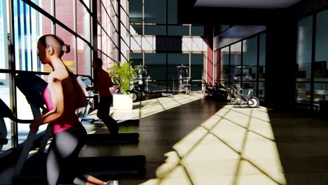 Gym-with-various-exercise-machines-in-it-and-people-walking-on-treadmill