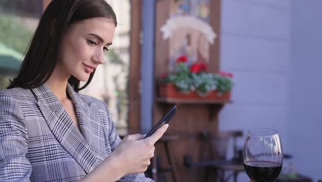 Beautiful-Woman-Taking-Food-Photos-On-Mobile-Phone-At-Restaurant