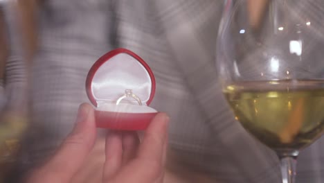 Man-Doing-Marriage-Proposal-To-Woman-In-Restaurant-Closeup