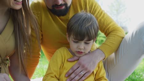 Parents-and-child-reading-a-book